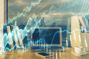 Financial graph colorful drawing and table with computer on background. Multi exposure. Concept of international markets.