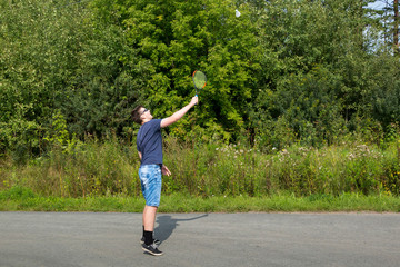 Teen boy with a racket in hand plays badminton