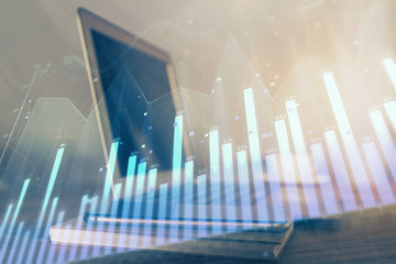 Forex market chart hologram and personal computer background. Multi exposure. Concept of investment.