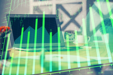 Stock market graph and table with computer background. Multi exposure. Concept of financial analysis.