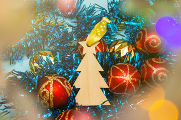 Fototapeta na wymiar Christmas tree decoration fur spruce shape on a background of bokeh and Christmas toys. Holidays preparations concept.