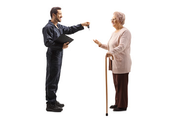 Mechanic giving car keys to an elderly woman