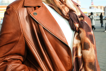 a plump girl in a brown leather jacket