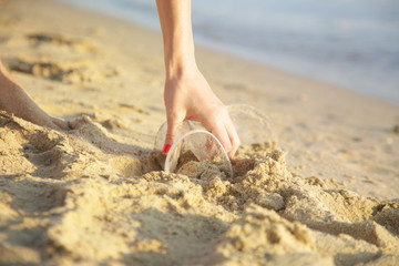 Volunteer woman collecting trash on the beach. Trash-free seas concept. Single-use plastic is a human addiction that is destroying our planet	