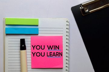 You Win You Learn write on sticky notes. Isolated on white table background