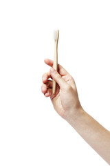 eco bamboo toothbrush in hand on white background