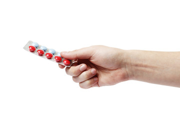 hand man holding color pills in blister pack on white background, close up