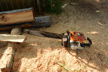 the old chainsaw with the timbers and stack of sawdust