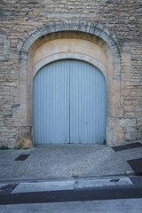 Fototapeta na wymiar A House With Old Wooden Door, Blue Gate in the Street, Gordes, France