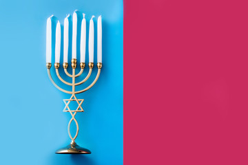 Jewish Hanukkah menorah on blue and pink background