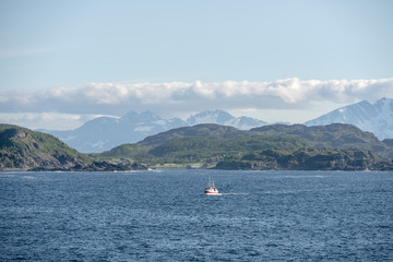 Fototapeta na wymiar traditional small fish boat sailing near the northern coast of Andenes island, Norway