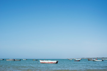 Fototapeta na wymiar Little boats on the sea. Daylight and blue water.