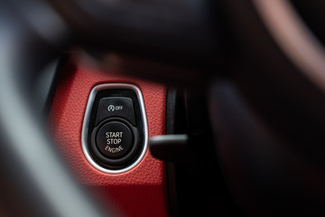 Close-up, isolated image of an engine Start Stop button seen on the dashboard of a german...