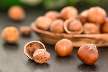 Hazelnuts on black stone background