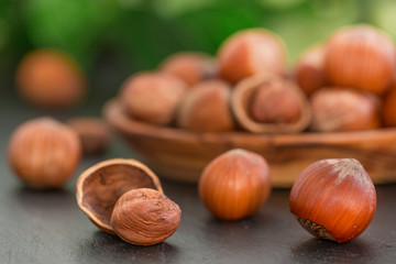 Hazelnuts on black stone background