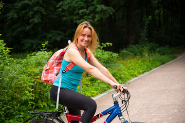 Beautiful girl on a bike in the Park