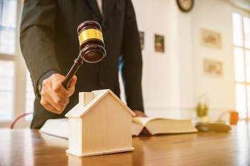 lawyer mediating in a property dispute .Auctioneer knocking down a property sale.Real estate sale auction concep.