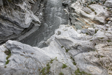 Fototapeta na wymiar Taroko Gorge is an impressive 19-km-long canyon, situated near Taiwan's east coast. The area of the gorge is also identified as Taroko Gorge National Park. The upward thrust of hard rock, combined wit