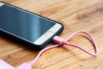 Smartphone charging battery from backup power source.