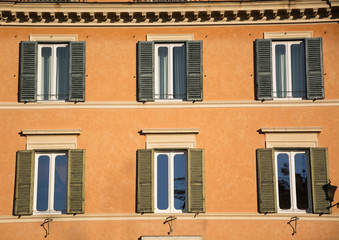 Windows and shutters of ancient Rome, old buildings facade