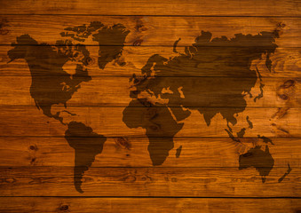 world map overlaid on brown wooden texture patterned background