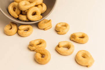 Taralli is a traditional Italian appetizer, similar to drying or bagels, typical of the cuisine of Sicily and Calabria. Bagel on a white background in a bowl.