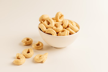 Taralli is a traditional Italian appetizer, similar to drying or bagels, typical of the cuisine of Sicily and Calabria. Bagel on a white background in a bowl.