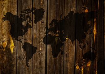 Conceptual image with world map on wooden wall