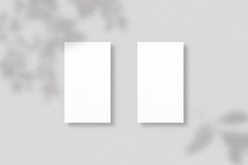 Blank business cards on grey background. Mockup of two vertical business cards with soft shadows. Template for branding identity. Photo mockup with clipping path.