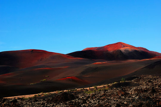 Picturesque view of volcanic terrain with solidified lava in wild area on island of Lanzarote Spain