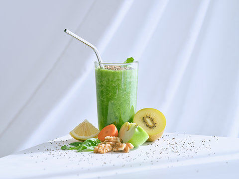 Set of ingredients for healthy smoothie and glass with green drink