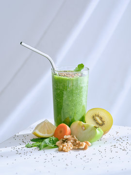 Set of ingredients for healthy smoothie and glass with green drink