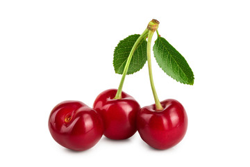 Three cherries with leaf closeup isolated on white background