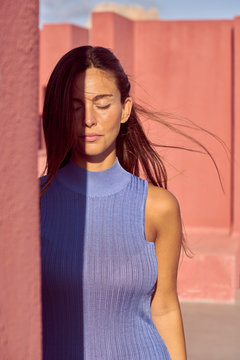 Close-up of a beautiful woman in blue dress with closed eyes