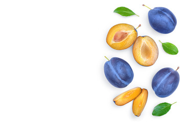 fresh blue plum and half with leaves isolated on white background with copy space for your text. Top view. Flat lay
