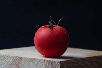 red tomato on wooden table