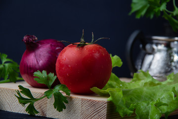 tomatoes and lettuce on wooden table