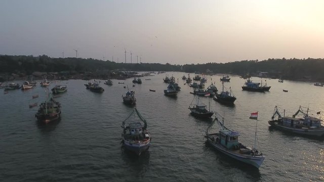 drone zoom in shot of  fishing boats in a small port on the west coast of India