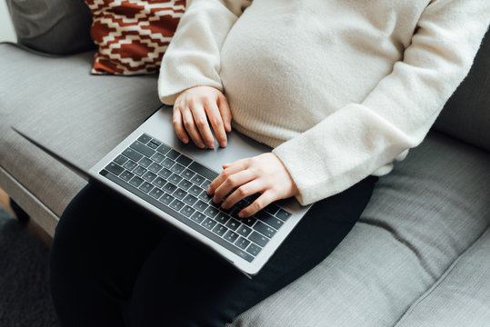 Pregnant woman using computer