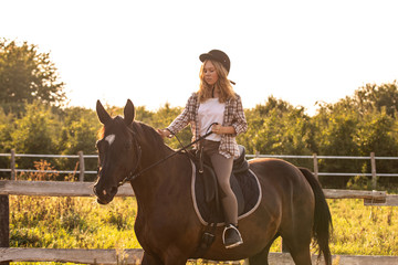 Young girl with her horse in evening sunset light