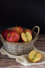 Apple in a basket on wooden table