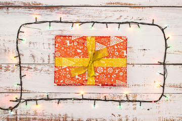 One gift surrounded with Christmas lights 