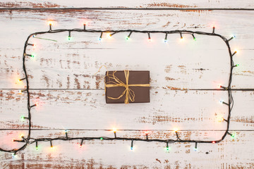 One gift surrounded with Christmas lights 