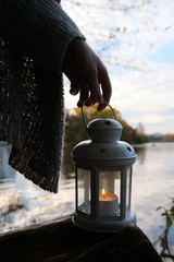 Girl holding the old lamp with candle on background of forest  © NKTN