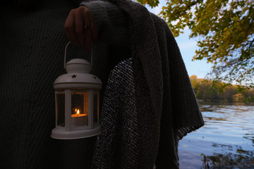 Girl holding the old lamp with candle on background of forest  © NKTN
