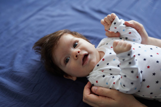 Baby laying in bed.