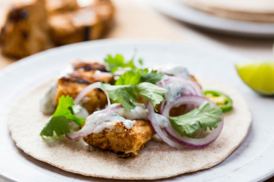 Chicken tikka wraps with Indian spices and condiments