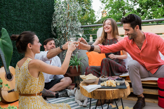 Friends toasting during a rooftop party