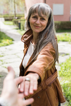 Senior woman holding hand outdoors