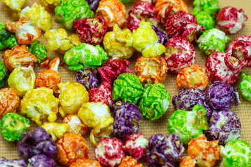 delicious colored popcorn isolated on yellow background